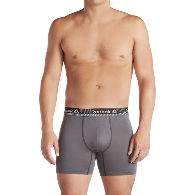 Reebok 3 Performance Boxer Briefs displayed on a male model from the waist down in a front-facing view, featuring grey boxer briefs with a contour pouch for added support and a black elastic waistband branded with the white Reebok logo, designed for men's underwear and suitable for both intense workouts and all-day wear.