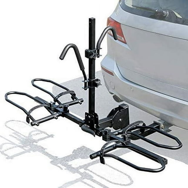 Leader Accessories 2-Bike Platform Style Hitch Mount Bike Rack attached to the rear of a vehicle. This tray-style bicycle carrier features a foldable and tilt-back design for easy access to the rear gate without detaching the rack. It is compatible with 2-inch hitch receivers and supports up to 70 lbs per bike, accommodating various frame sizes, including fat tire and electric bikes. The anti-wobble system ensures stability, and the rack includes a safety reflector and tie-down strap for added security.