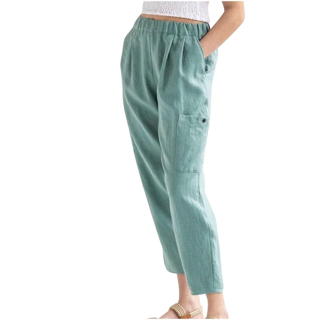 Woman Solid Color Cotton And Linen Loose Casual Wide Leg Nine-Quarter Pants in a light green shade. The pants feature a relaxed fit with an elastic waistband, side pockets, and a special ankle-length design. Made from a cotton and linen blend, suitable for casual and recreational occasions. Shown paired with a white top and sandals.