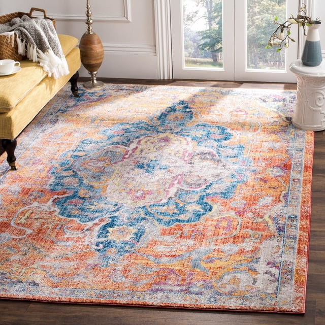 SAFAVIEH Bristol Waverly Traditional Area Rug featuring a distressed antique pattern in muted blue, orange, and cream polyester fibers, laid on hardwood flooring in a bright living room corner beneath a yellow sofa with a gray throw, next to a wooden floor lamp and white ceramic side table with a vase, suitable for adding vintage charm to modern home decor.