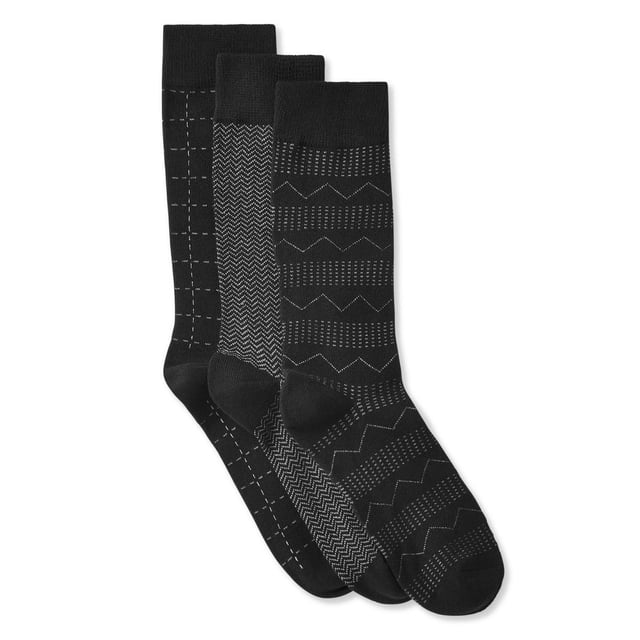 George Men's Crew Socks feature three pairs of black crew-length socks with elasticized ankles, each pair showcasing unique white geometric patterns including grid, chevron, and zigzag designs, made from a polyester blend fabric suitable for everyday and office wear.