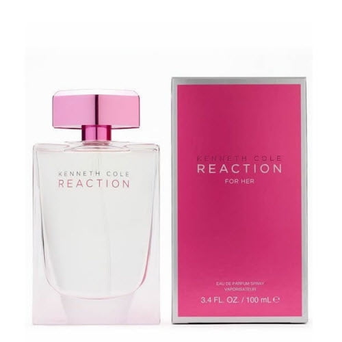 Kenneth Cole Reaction by Kenneth Cole for Women - 3.3 oz EDP Spray. A floral fragrance launched in 2005 featuring notes of grapefruit, mandarin, orchid, sweet pea, lily of the valley, musk, votive mist, cottonwood, and white amber. The image shows a clear glass bottle with a pink cap alongside its matching pink and silver packaging.