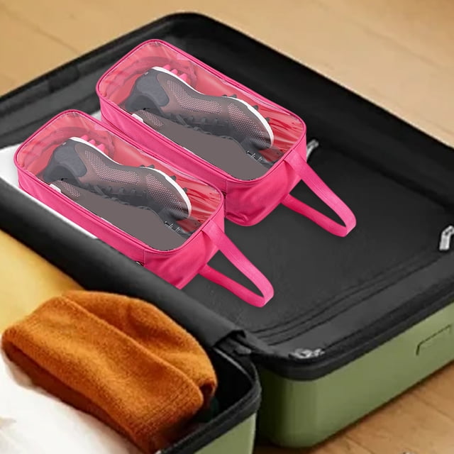 Fridja Travel Shoe Bag in hot pink, featuring a transparent waterproof design for easy visibility and organization. Made from durable oxford cloth, this washable and reusable shoe storage pouch measures 34x17x11 cm and is shown holding shoes inside a suitcase. Ideal for travel, daily use, and protecting shoes from dirt and moisture.