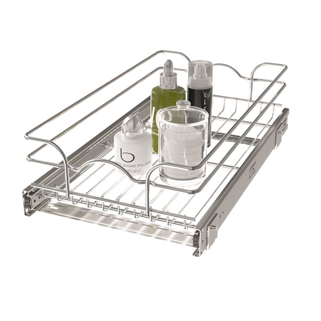 Rev-A-Shelf Kitchen Cabinet Pull Out Shelf Organizer, 12 x 20 In, 5WB1-1220CR-1. A silver wire pull-out basket with smooth ball-bearing slides, designed for kitchen cabinets. The organizer is shown holding bottles and containers, demonstrating its use for storing pots, pans, and other kitchen accessories. Measures 19.75 inches deep, 11.5 inches wide, and 5.56 inches tall, fitting 15-inch cabinets with 11.5-inch openings. Includes mounting hardware; optional door mount kit sold separately.