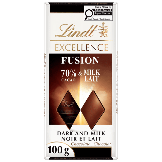 Lindt EXCELLENCE Fusion 70% Dark & Milk Chocolate Bar, 100g, showing white packaging with gold and black text, featuring two diamond-shaped pieces representing 70% dark cacao and milk chocolate, with a Health Canada label warning of high saturated fat and sugars, suitable for enjoying a rich and creamy chocolate blend.