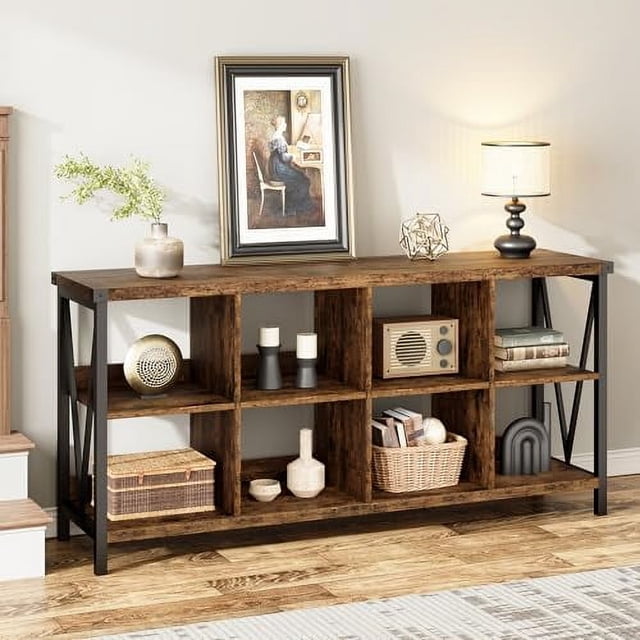 Console Table 62.2'' Narrow Sofa Table with 8 cube storage organizer cabinet, finished in grey brown with a pedestal base. The table features three tiers and a V-shaped design for stability, measuring 13.4 inches deep, 62.2 inches wide, and 30.3 inches high. Displayed in a living room setting, it holds decorative items like vases, books, and a lamp. Ideal as a multi-functional console table for entryways, living rooms, or foyers.