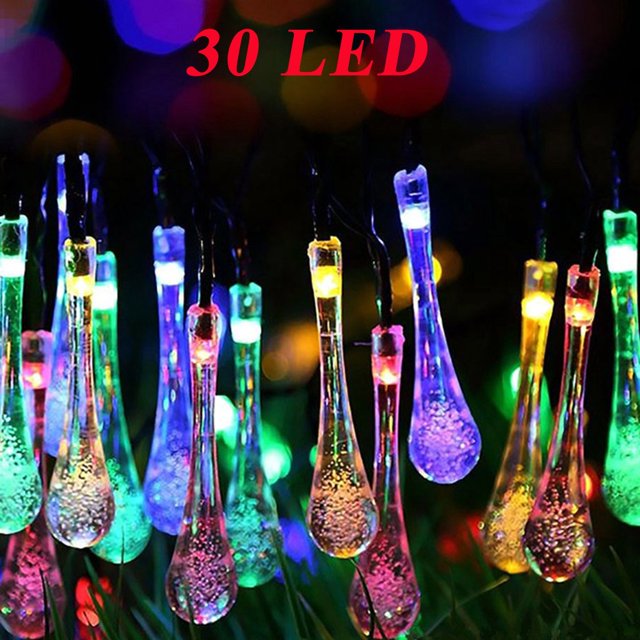 EGNMCR Light Strip, Christmas Lights Outdoor Garden Party 30 LED Teardrop Solar Garden Lantern String. A string of 30 multicolored teardrop-shaped LED lights, powered by a 2V 100MA solar panel with a rechargeable NI-MH AA 600MA battery. The lights offer two modes: steady and flashing, and are suitable for outdoor use in gardens, patios, or festive events. The 6.5-meter string features a 300-degree rotatable solar panel for efficient charging and includes a durable plastic fixing nail for secure installation. Ideal for creating a festive or ambient atmosphere.