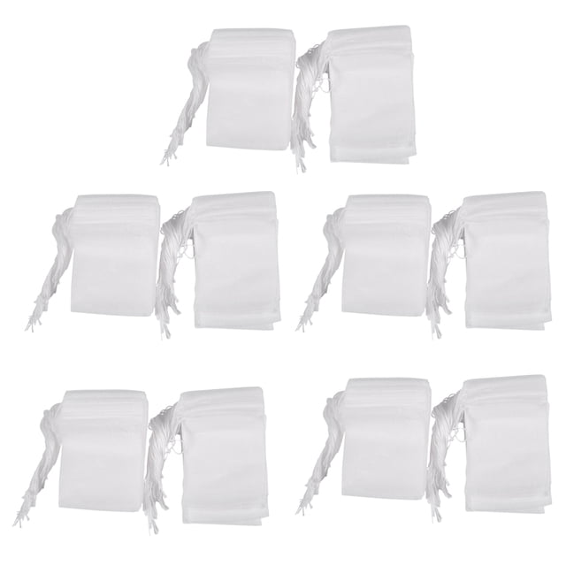 500 Pcs Disposable Empty Tea Bag String Heat Seal Filter Paper, shown in multiple stacks of white drawstring tea bags. Made from natural, high-grade filter paper, these bags are suitable for tea, spices, and herbal powders. Each bag measures 5cm x 6cm and is sealed with a drawstring. Ideal for single-use applications, the package includes 5 sets of 100 bags each.