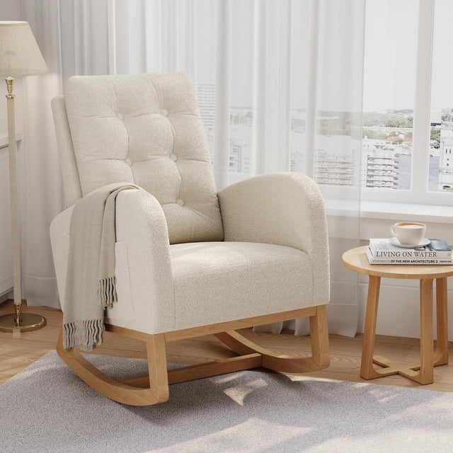 Twister.CK Modern Rocking Accent Chair, Upholstered Rocker Glider with Side Pocket, shown in a white soft-touch fabric with a tufted backrest and rounded armrests. The chair features a durable hardwood frame with a smooth rocking base and non-slip pads. Positioned in a bright living room with a side table and a cup of coffee, it is ideal for nurseries, bedrooms, or relaxation spaces.