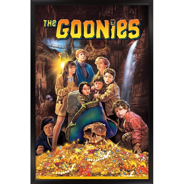 The Goonies - One Sheet Wall Poster, 22.375" x 34" depicting a group of children in a cave holding a lantern, standing behind a large pirate skull wearing a blue tricorn hat atop a treasure pile of gold coins, pearls, and jewels, with a waterfall and rope bridge in the background, ideal for wall art and themed room décor.