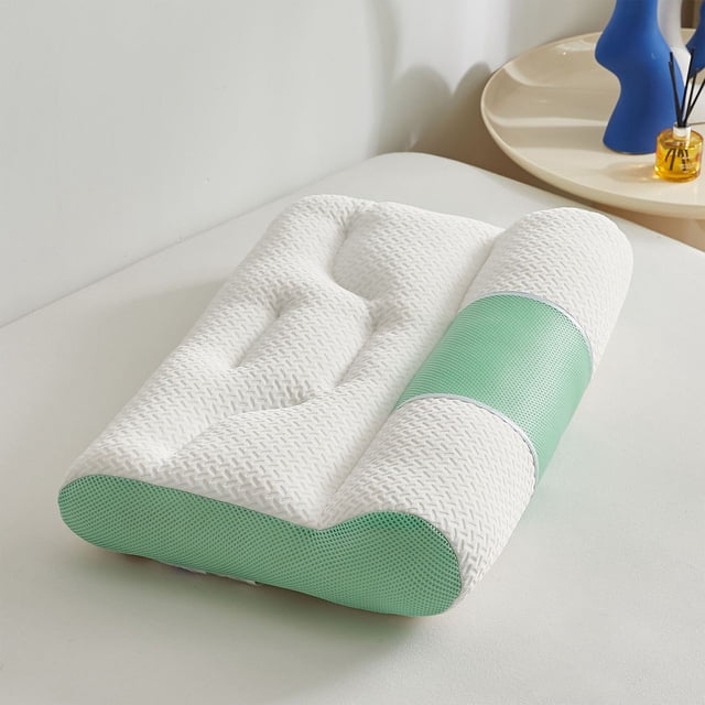 Styesk Ergonomic Cotton Cervical Memory Foam Pillow for Sleep Enhancing Comfort, a rectangular bed pillow with a contoured design for neck support. The pillow has a white knitted cotton cover with green accents, designed for cervical spine protection and comfort in various sleeping positions. Ideal for side, back, and stomach sleepers, shown on a bed in a minimalist bedroom.