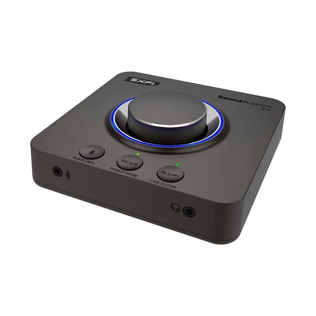 Sound Blaster X4 External Sound Card with a multicolour design, featuring a large illuminated control knob and buttons for audio balance, mode selection, and Super X-Fi activation. Includes USB DAC functionality, ports for optical-in, optical-out, line-in, mic-in, and headset connectivity. Supports 7.1 discrete surround sound, Dolby Digital Live, and gaming audio customization.