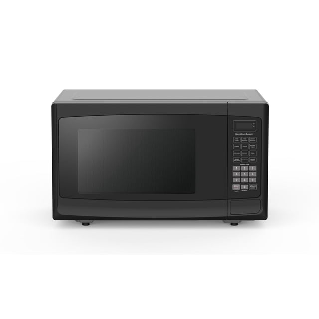 Hamilton Beach 1.1 Cu. ft. Compact Microwave in black with a front-facing view showing a large rectangular door with a mesh window and a digital touchpad control panel on the right featuring one-touch cooking buttons for popcorn, potato, pizza, and numeric keypad, standing on small feet on a white background. Its compact size and 1000-watt power make it suitable for efficient cooking and reheating.