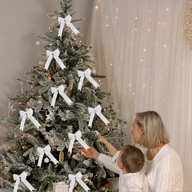 Dvkptbk Christmas Bow Hand Made Ear Ribbon Lovely Ribbon Polyester Ribbon Bow Dovetail Bow Christmas Tree Decoration used as festive toppers on a Christmas tree. The white bows with dovetail ends add elegance to the holiday decor. A child and an adult are seen admiring the tree in a cozy, holiday-themed room.