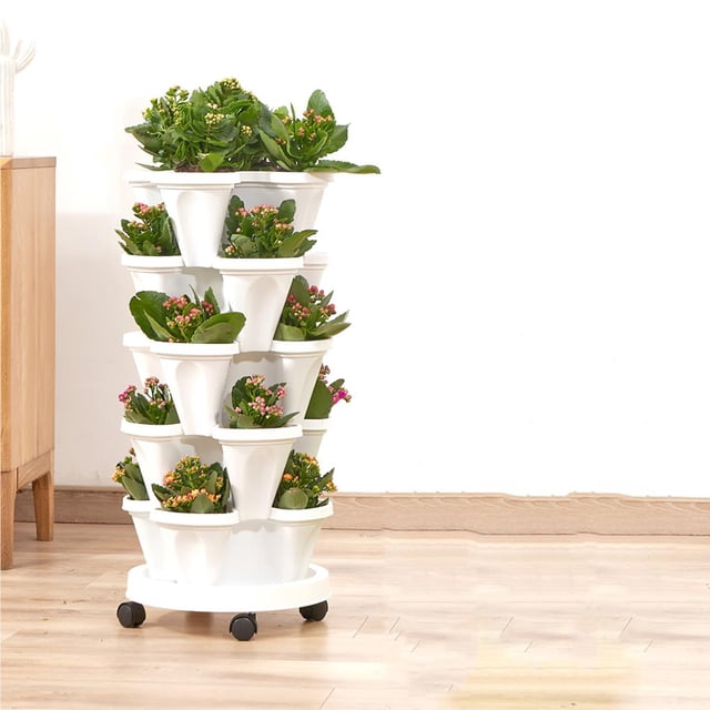 Stacking Planter with Drainage Holes Load-Bearing Simple Removable Space-Saving Planting Pot Multifunctional Large Petal Flower Container Growing Type1. A white, multi-tiered stacking planter made of durable plastic, featuring a space-saving design with multiple compartments for planting flowers or small plants. The planter is equipped with drainage holes and sits on a removable base with wheels for easy mobility. It is shown in a bright indoor setting with vibrant green and pink plants in each tier, making it suitable for home, balcony, or garden decoration.