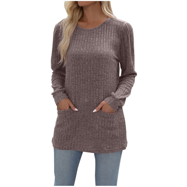 FAIWAD Womens Tunic Top Round Neck Long Sleeve Ribbed Solid Color Lightweight Pullover Top with Pockets. The image shows a relaxed-fit tunic top in a ribbed texture, featuring a round neckline, long sleeves, and two front pockets. The top is styled in a neutral solid color and paired with light blue jeans, suitable for casual outings or everyday wear.