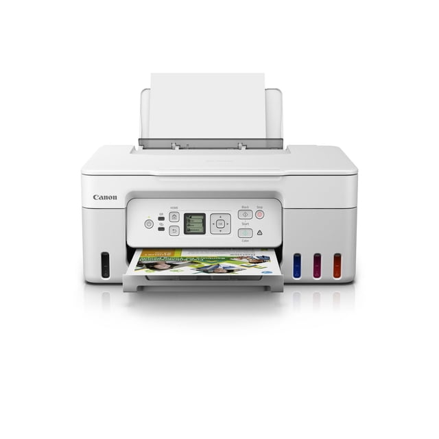 Canon PIXMA MegaTank G3270 Wireless All-in-One Printer in white, front-facing with paper loaded in rear tray and a colour photo print emerging. Features a 1.35-inch square LCD screen, visible cyan, magenta, and orange ink tanks, and control buttons for black, colour, start, and stop. Compact design for home or office use with wireless connectivity and high page yield, also suitable for printing banners and photos.