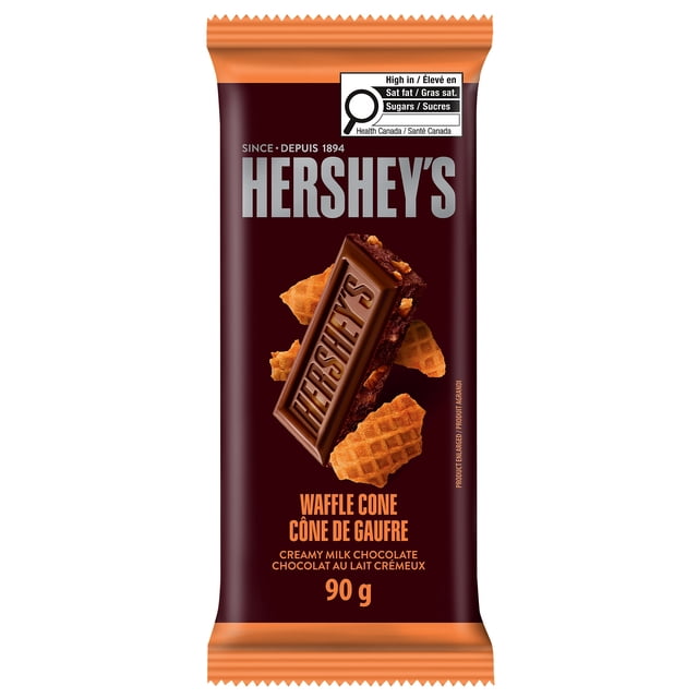 Hershey's Milk Waffle Cone 90G chocolate bar with creamy milk chocolate and crunchy waffle cone pieces on a dark brown wrapper featuring bilingual English and French text and a Health Canada nutrition warning, suitable as a sweet snack or treat.