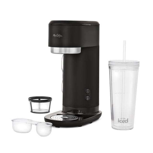 Mr. Coffee Single-Serve Iced and Hot Coffee Maker in matte black with silver trim, featuring a compact vertical design, two front control buttons, reusable coffee filter, dual-sided scoop, and clear reusable tumbler with lid and straw for brewing bold hot or refreshing iced coffee at home.