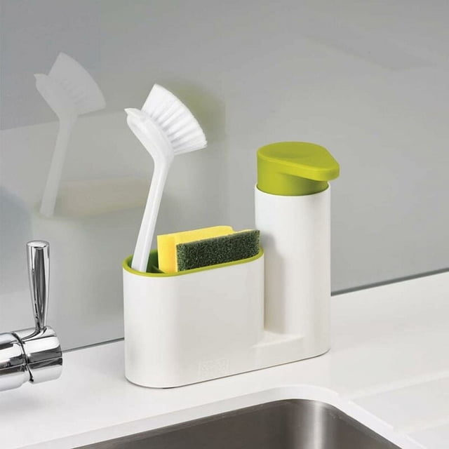 Sink Caddy Set by Dutchman, featuring a white and green dishwashing organizer with an integrated storage tray, easy-push pump head, and ergonomic design. The set includes compartments for a dish brush, sponge, and soap dispenser, ideal for seamless cleaning in kitchens or bathrooms. Positioned on a white countertop near a sink.