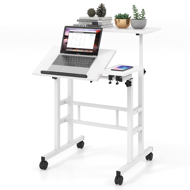 Gymax Adjustable Computer Desk Mobile Stand up Desk Tilting Workstation in white, designed with two height-adjustable platforms. The upper platform adjusts between 28.5 and 49.5 inches, and the lower platform adjusts between 28.5 and 46 inches. The front platform tilts for ergonomic use and includes a baffle to secure items. Constructed with a durable MDF and steel frame, it features four swivel casters, two with locks for stability. The desk offers ample space for laptops, books, and office supplies, ideal for compact spaces or as a mobile workstation.