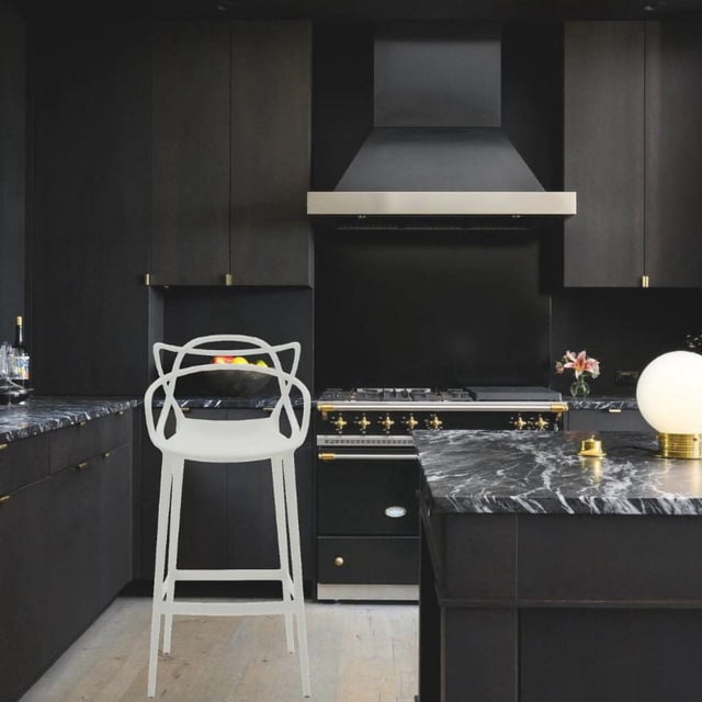 Take me Home Furniture - kooper tangled polypropylene Modern-Mid Century Stool in white, placed in a modern kitchen with black cabinetry and black marble countertops, featuring a lightweight, durable polypropylene frame and an ergonomic tangled-weave seat, suitable for indoor or outdoor use.