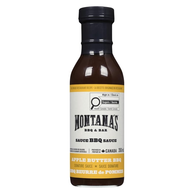 MONTANA'S BBQ APPLE BUTTER SAUCE in a 350 ml glass bottle with black cap, featuring a white and yellow label describing a creamy, fat-free sauce with rich apple, tomato, and smoke flavors, made in Canada and ideal for grilling or dipping.