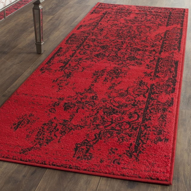 Safavieh Adirondack Zoey Traditional Faded Area Rug with red and black abstract floral and geometric patterns, crafted from durable polypropylene yarn and power loomed in Turkey, ideal for rustic lodge-inspired home décor on hardwood floors.
