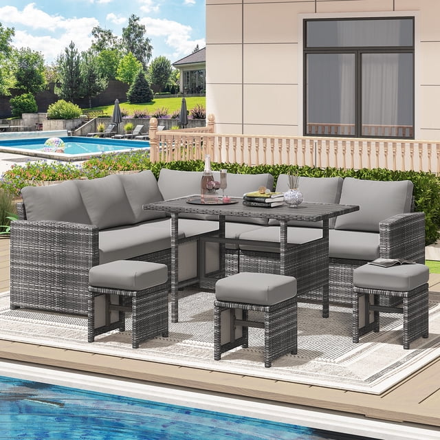AECOJOY 7 Pieces Patio Furniture Set in grey, featuring hand-woven PE rattan sectional sofas, ottomans, and a spacious wood-plastic composite table. Ideal for outdoor living, this conversation set is arranged poolside on a patio, showcasing its modern design and comfortable cushions.