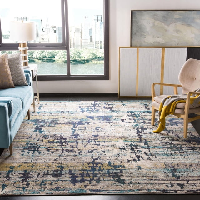 SAFAVIEH Madison Roswell Vintage Abstract Area Rug in a modern living room with city views. The power-loomed rug features a transitional abstract pattern in blue, beige, and yellow tones, placed under a blue sofa and beige armchair with a yellow throw, ideal for durable accent rug use.
