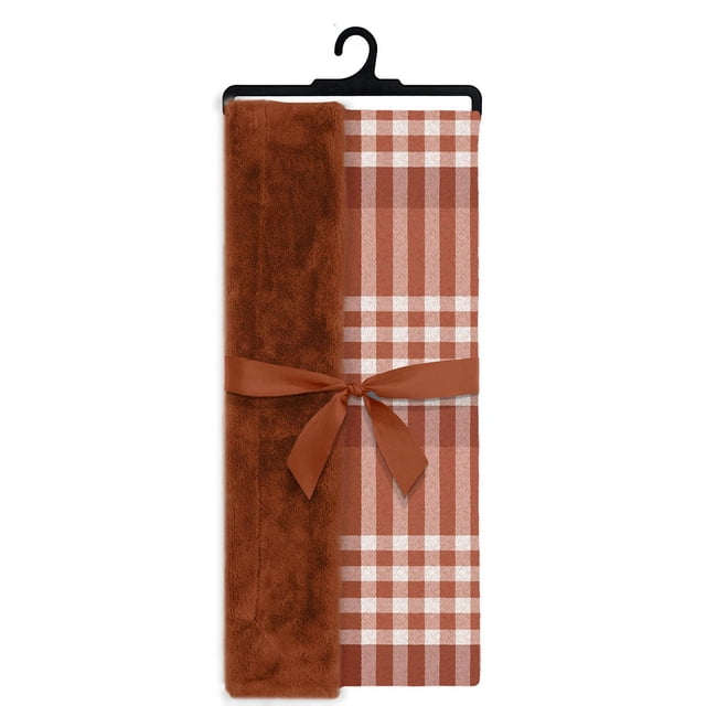 Printed Faux Fur Throw Marmalade folded on a black hanger with a tied marmalade-coloured ribbon, featuring a classic plaid pattern in marmalade and white, soft faux fur texture on one side, made of durable polyester for lightweight warmth and easy care.