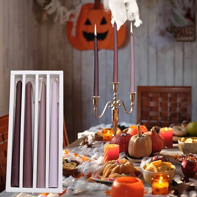 Rkxzt Taper Candles 10'' tall candlesticks set of 4 displayed in a white box alongside a festive table setting. The candles are sleek and long-stemmed, shown in shades of pink and purple, placed in a gold candelabra surrounded by autumn-themed decor, including pumpkins, desserts, and glowing candles. Perfect for mantle home decor, kitchen, wedding, birthday, and Christmas centerpiece decorations. These aromatherapy candles offer a long-lasting burn and are crafted with natural wax for safe use.