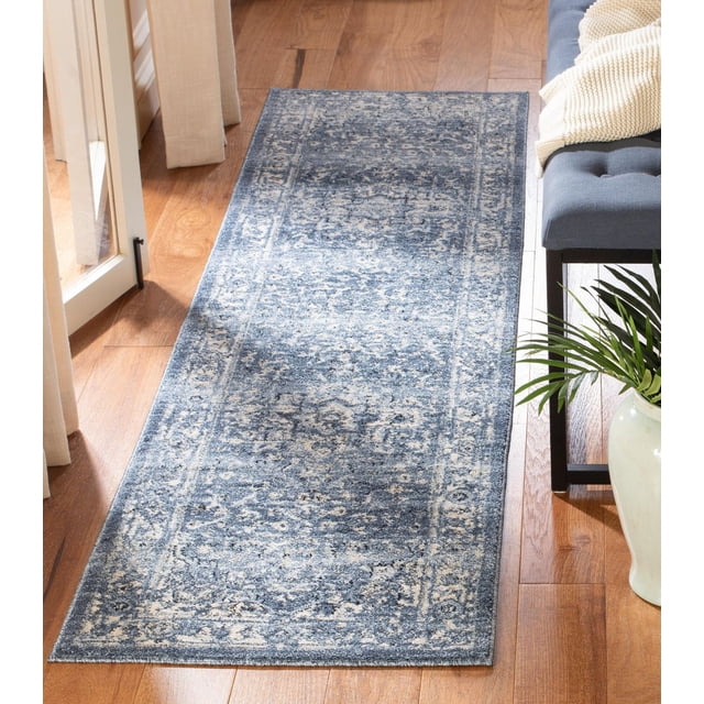 SAFAVIEH Charleston Zharko Overdyed Floral Area Rug with traditional floral pattern in blue and cream tones, power loomed synthetic yarn construction, shown on hardwood floor beside a gray bench with cream throw, ideal for classic home decor and suitable as an accent rug in living or dining rooms.