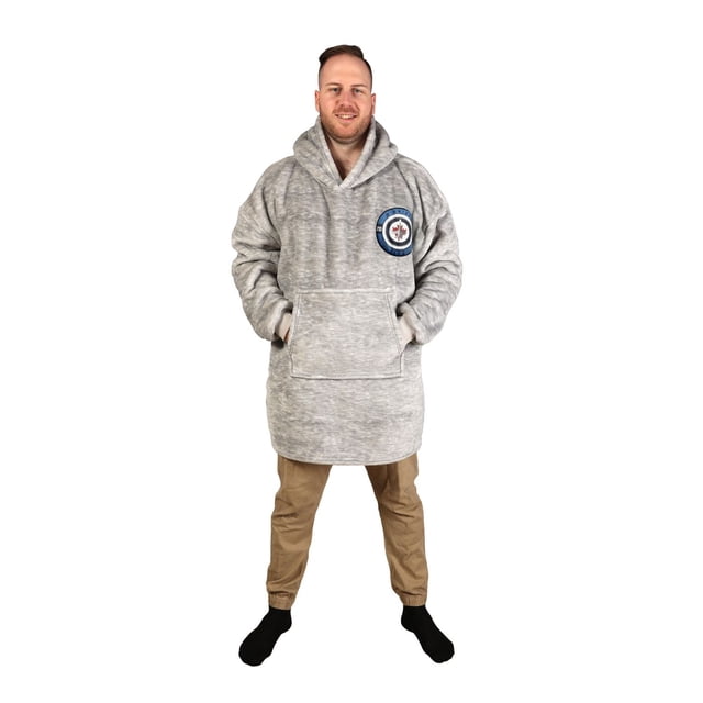 NHL Winnipeg Jets Game Time Wearable Hoodie Blanket in grey worn with hands in the front kangaroo pocket, featuring the official embroidered Winnipeg Jets logo on the chest, made of plush sherpa fabric with an oversized hooded design suitable for indoor and outdoor use.