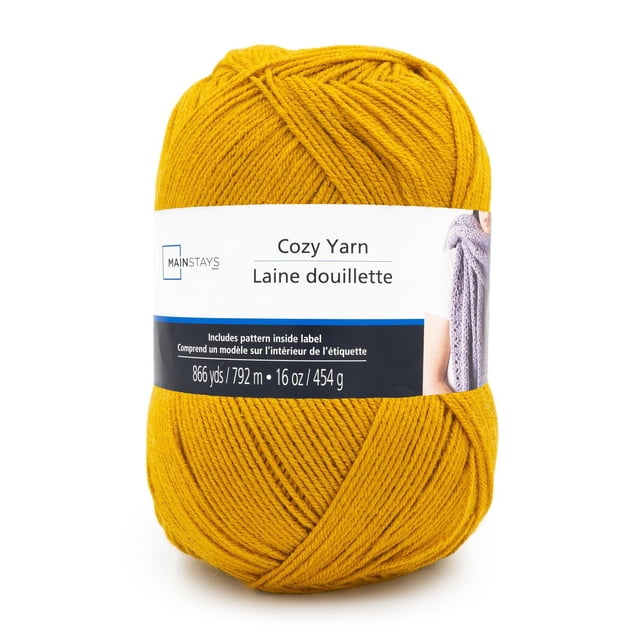 Mainstays Cozy Medium Acrylic Yarn 1 Ball in mustard yellow, 4-ply medium weight acrylic yarn weighing 454g (16 oz) with 792m (866 yds) length, featuring a label with knitting pattern and bilingual English-French text, ideal for crafting afghans, garments, and accessories.