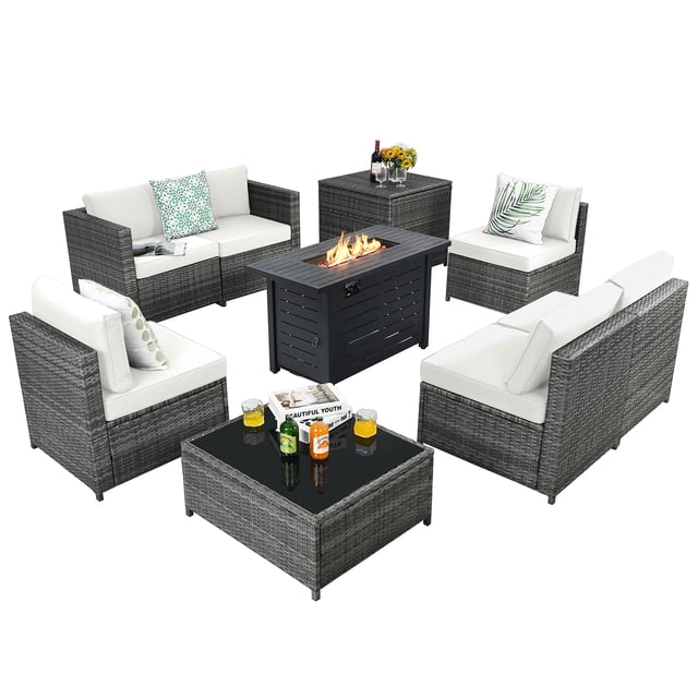 Patiojoy 9 PCS Rattan Dining Set featuring a wicker sofa with off-white cushions, a propane gas fire pit table with a 60,000 BTU heater, a glass-top coffee table, and a storage box. The set includes six modular sofas with soft, detachable cushions for easy cleaning, a durable steel frame with a weather-resistant rattan weave, and adjustable anti-slip foot pads. The fire pit table doubles as a coffee table and includes a waterproof PVC cover for protection. Ideal for indoor and outdoor use, this set offers ample seating and storage, making it perfect for gatherings in gardens or patios.