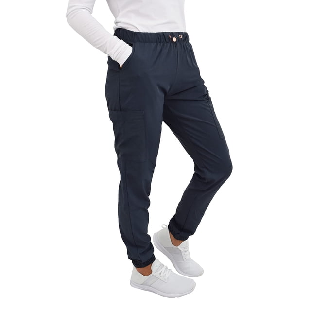 gT Performance Pantalon d'Uniforme Médical pour Femmes Style Jogger Coupe Ajustée en Étain, Taille Très Petite. Ces Pantalons d'Uniforme Style Jogger Offrent une Coupe Ajustée Moderne avec une Taille Élastique et une Fermeture à Cordon en Oeillets Or rose. Fabriqué en Mélange durable de 93 % polyester et 7 % Élasthanne, le Tissu Est Infroissable, Non Transparent, et Offre une Extensibilité Quatre Sens pour le Confort et la Mobilité. Comprend Deux Poches de Hanches à Coupe Évasée et Deux Poches cargo pour la Fonctionnalité. Montré sur une Vue Latérale avec Ourlets de Jogger Élastiques et