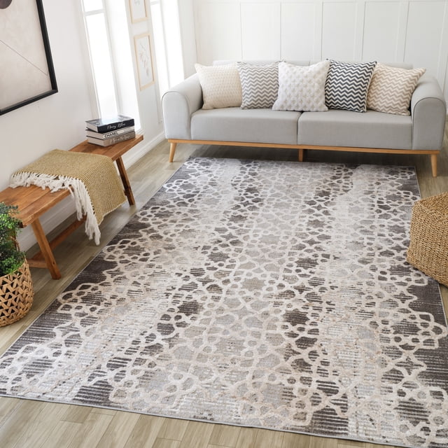 Rug Branch Cadence Abstract Indoor Area Rug in brown beige with a modern geometric pattern, measuring 5'3" x 7'7", placed on light wood flooring in a living room featuring a light gray sofa with five patterned cushions, a wooden bench with a mustard throw, and a woven basket planter, ideal for living room, bedroom, dining room, or kitchen.