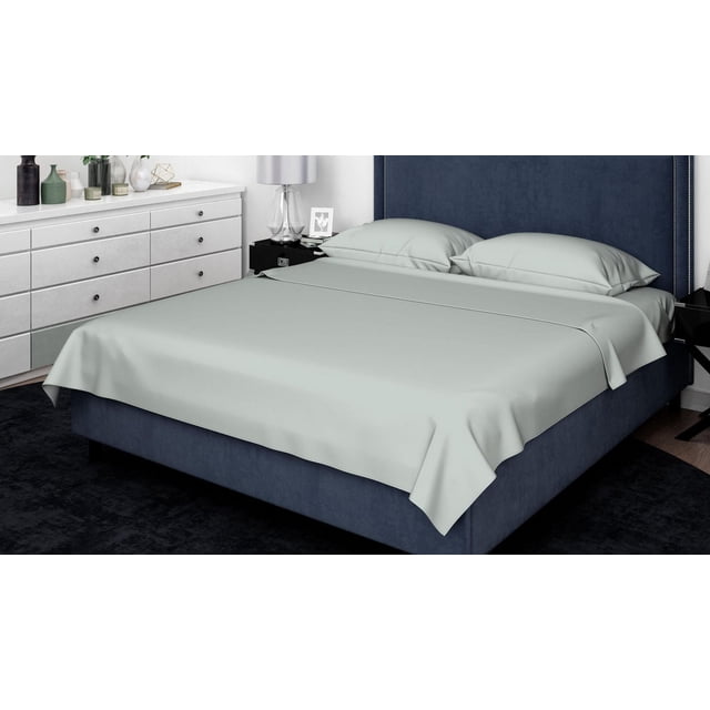 Johnson Home 300 Thread Count Combed Egyptian Cotton Sheet Sets in light grey on a navy blue upholstered bed with nailhead trim headboard, including two pillowcases, set in a modern bedroom with white dresser and black nightstand, offering breathable, soft, and durable bedding ideal for year-round comfort.