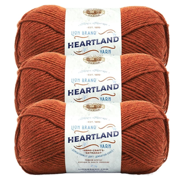 Lion Brand Yarn Heartland Yarn 3Pack in rust orange, featuring three skeins of medium worsted weight acrylic yarn with a soft, heathered texture, machine washable and durable, each wrapped with a white label displaying the brand and product name, suitable for crafting warm, long-lasting projects.