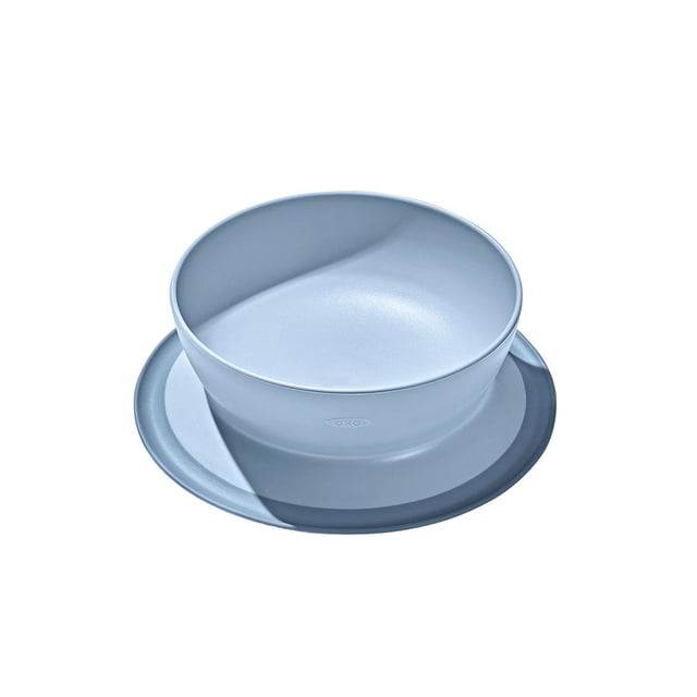 Oxo Tot Stick & Stay Suction Bowl in dusk blue with tall walls and a wide suction base that prevents sliding and tipping, designed for toddler tableware to support self-feeding and easy scooping during mealtime.