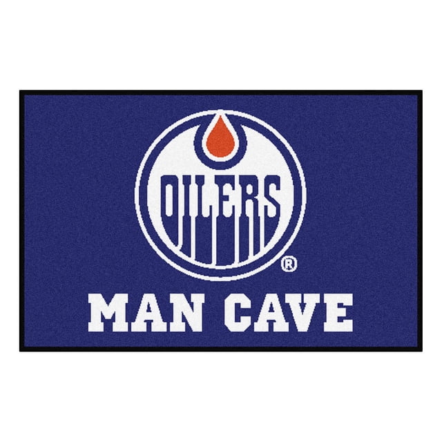 LNH Oilers d'Edmonton Tapis Grotte pour Homme Mesurant 19 par 30 Pouces avec un Visage Bleu 100 % nylon, Présentant le logo Oilers d'Edmonton en Blanc et orange au-Dessus du Texte Blanc Audacieux « Man Cave », Bordure Noire, et Endos en Vinyle Recyclé Antidérapant pour la Durabilité, Lavable à la machine et Convient aux Cabanes de Fans Ou aux Bureaux, Aussi Souvent Utilisé comme Tapis d'Accent Décoratif.