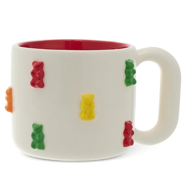 Haribo Gummy Bears 16 fl oz Ceramic Sculpted Mug with a white ceramic exterior featuring colorful 3D gummy bear accents in red, green, yellow, and orange, a vibrant red interior, and a large handle, microwave and dishwasher safe, suitable for coffee, tea, or hot cocoa.