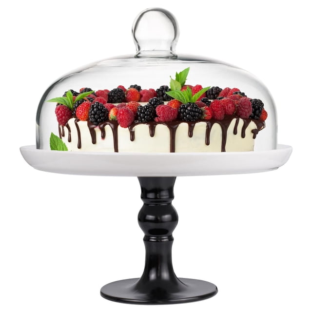 Footed Pedestal Cake Stand and Clear Dome 25 cm with a white porcelain plate and black pedestal base, topped by a clear glass dome covering a cake decorated with chocolate drips, fresh raspberries, blackberries, strawberries, and mint leaves, ideal for serving and displaying desserts while keeping them fresh.