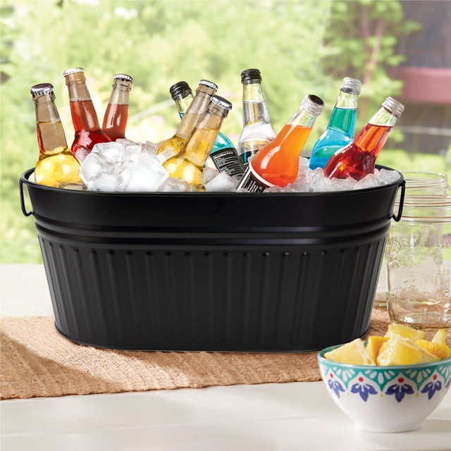 Hometrends Black Large Oval Tub 24x14.37 inches made of galvanized steel with powder coating, filled with ice and assorted bottled beverages, featuring durable wire handles for easy carrying, suitable for chilling drinks or use as a party ice bucket.