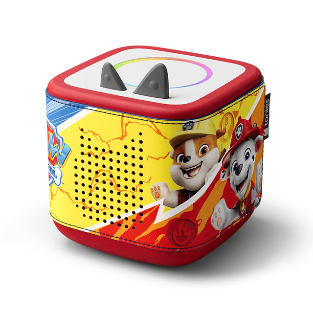 tonies Toniebox 2 Sleeve: PAW Patrol with a snug-fitting colorful sleeve featuring characters Rubble and Marshall on a yellow and red background, speaker holes for clear sound, and stitched details on a cube-shaped educational audio player for kids with gray ears on top.