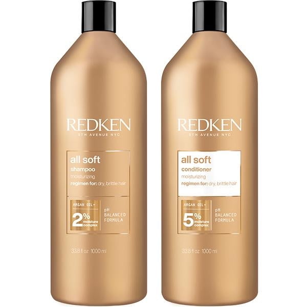 REDKEN DUO All Soft Shampoo and Conditioner hair care set, featuring two 1-liter bottles. The shampoo and conditioner are formulated to moisturize dry, brittle hair with an argan oil and keratin blend that restores shine, softness, and suppleness. Both bottles have a sleek gold design with clear product labeling.