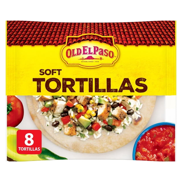 Old El Paso Soft Flour Tortillas package containing 8 large, soft wheat tortillas shown with a filling of grilled chicken, rice, black beans, corn, avocado, and diced red peppers, alongside fresh tomato, jalapeño, and a bowl of salsa on a white background, suitable for making tacos, burritos, and quesadillas.