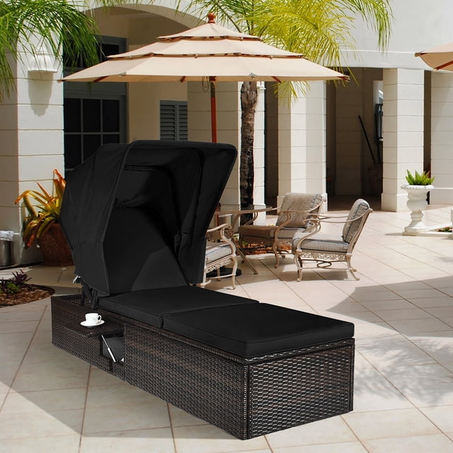 Costway Patio Rattan Lounge Chair Chaise Cushioned Top Canopy Adjustable Tea Table Black. A black PE rattan chaise lounge with a retractable canopy, adjustable backrest, and cushioned seat, featuring a compact side table for added convenience. Made from weather-resistant materials, ideal for outdoor use in poolside, garden, or beach settings.