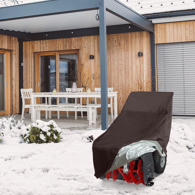 EGNMCR Snow Blower Cover, a universal fit snow thrower cover made of durable brown polyester fabric, displayed outdoors in a snowy environment. The cover is waterproof, UV-protected, and dirt-proof, featuring a drawstring and windproof buckles for secure outdoor protection. Designed for most two-stage snow blowers, it measures 47.24 inches in length, 32.28 inches in width, and 40.16 inches in height, providing all-weather protection against snow, dirt, and UV rays.